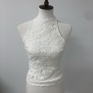 A white tank top with lace on the front